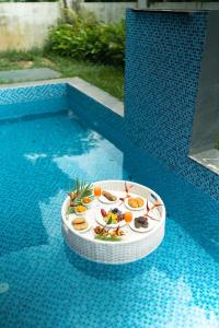 een bord met eten bovenop een zwembad bij Casa Verdea 4-BHK Villa With Private Pool & Lift Near Popular Restaurants in Siolim +57 foto's