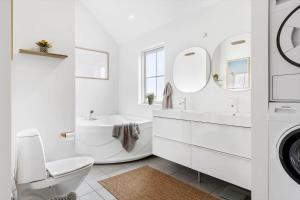 a white bathroom with a sink toilet and a washing machine at HA386-Hals-Merkurvej-91 in Hals +24 photos
