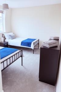 a room with two beds and a table in it at Spacious 3-Bed Contractor-Friendly Home in Bristol