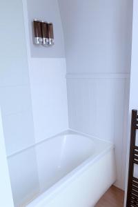 a white bath tub in a bathroom with a window at Spacious 3-Bed Contractor-Friendly Home in Bristol +13 photos