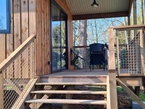 a screened in porch of a house with a tv on it at Les Cabanes d'Isa - Cab'Fer in Flexanville