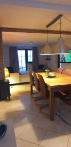 a dining room with a wooden table and chairs at Weitblick in Wadgassen