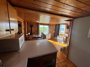 a kitchen with a counter top and a living room at PEI Cottage Rental in Borden-Carleton