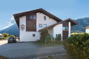 a white house with a brown roof at Ferienwohnung Sophia Inzell - Neu in Inzell