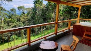 a balcony with a table and chairs and trees at Green mount in Medellín