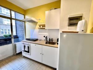 a small kitchen with a sink and a refrigerator at Nice & cosy studio in Mellet