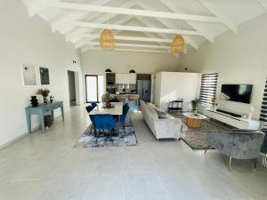 a living room with a couch and a table at 44 Staycation Beach-house in Britannia Bay