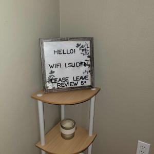 a shelf with a sign on top of a wall at LSU Den in Baton Rouge