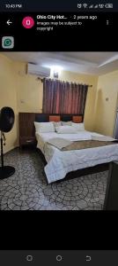a bedroom with two beds in a room at Ohio city hotel in Owerri +11 photos