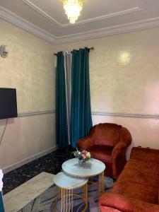 a living room with a couch and a chair at Air-conditioned apartment, secured Residence Kribi in Kribi