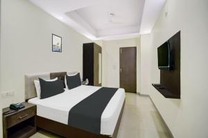 a bedroom with a large bed and a television at HOTEL O HAPPY PLACE HOTEL & RESORT in Gaya