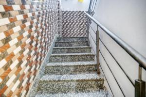 a spiral staircase in a building with tiles at HOTEL O HAPPY PLACE HOTEL & RESORT in Gaya