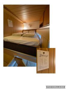 a small room with two beds and a calendar at Ferienwohnung am Möhntal in Heidenheim an der Brenz