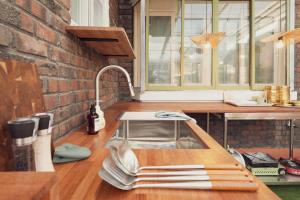 a kitchen with a sink and a brick wall at Chun cheon Bongstay 2nd Floor in Chuncheon +69 photos