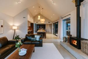 a living room with a couch and a fireplace at Riverslea in Wanaka