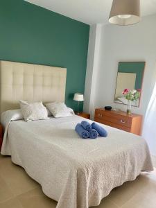 a bedroom with a bed with two towels on it at Tranquilidad y Relax in Torrox Costa