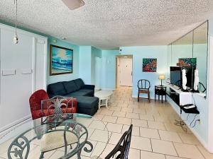 a living room with a couch and a table at The Salty Fountain in Seabreeze