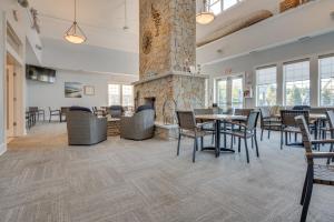 a lobby with a stone fireplace and tables and chairs at Stylish Arundel Cottage, 6 Mi to Dock Square! in Arundel