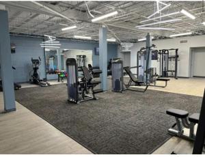 a gym with treadmills and machines in a room at The Reserve at Irondale in Birmingham