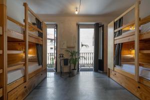 a room with two bunk beds and a balcony at The Hat Madrid in Madrid