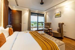 a bedroom with a large bed and a large window at Gardenia 4-BHK Farmhouse with Private Pool, Game Zone, & Lush Garden in Dera Māndi