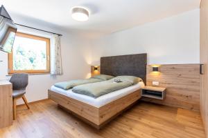 Postel nebo postele na pokoji v ubytování Obermühlhof Apartments
