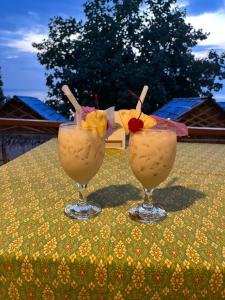two drinks sitting on top of a table at Kim house Koh Jum in Ban Ko Phrao