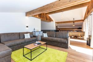 萨菲登安斯泰内嫩米尔Obermühlhof Apartments的客厅里有一张沙发和一张桌子。