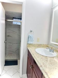 a bathroom with a sink and a shower at Main Villa 15 mins from Theme Parks & MCO in Kissimmee