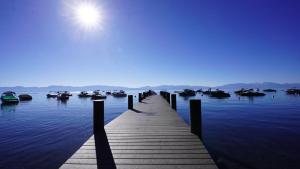 a dock in the water with boats in the water at Modern 3BR Tahoe Cabin with Hot Tub in Tahoe City