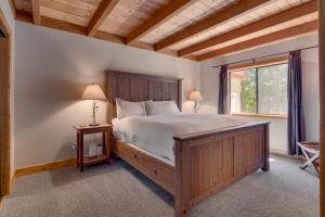 a bedroom with a large bed and a window at Modern 3BR Tahoe Cabin with Hot Tub in Tahoe City