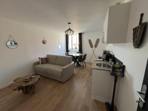 a living room with a couch and a table at Oasis Africaine in Lens +2 photos
