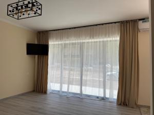 a room with a large window with curtains at Areni Vista Guesthouse in Areni