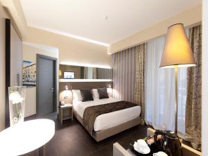 Posteľ alebo postele v izbe v ubytovaní Quirinale Luxury Rooms