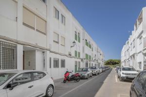 a row of cars parked on the side of a building at Casa Ricardo in Barbate