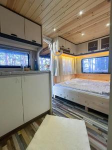an interior view of an rv with a bed and cabinets at Къмпинг Alino Lake in Alino