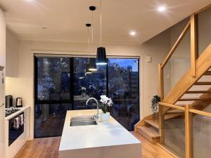 a kitchen with a sink and a large window at Modern Port Melbourne 3b3b Townhouse and Parking in Melbourne +24 photos