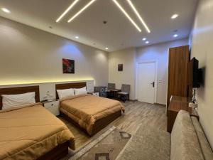 a hotel room with two beds and a television at Central Cairo Inn in Cairo