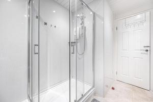 a shower with a glass door in a bathroom at City Centre Apartment in Dunfermline +17 photos