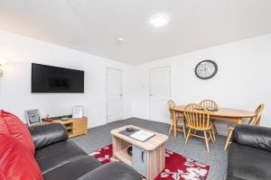 a living room with a couch and a table at City Centre Apartment in Dunfermline