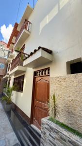 a house with a brown door on a street at Room in the City Center in Ayacucho