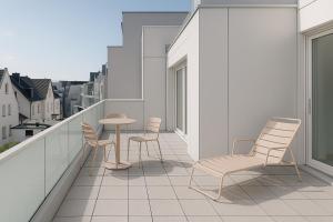 a balcony with chairs and a table on a building at Ferienstube alte Teestube Norderney in Norderney