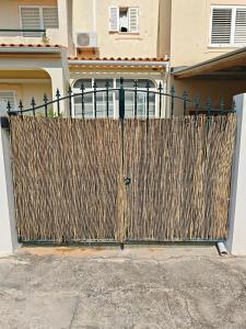 a wooden fence in front of a house at Santos Studio in FAO +1 photo