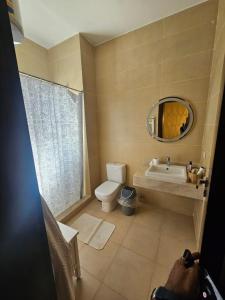 a bathroom with a sink and a toilet and a mirror at فيلا Azha بالعين السخنه للعائلات in Ain Sokhna