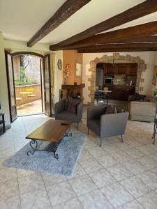 a living room with a table and chairs and a living room at Villa la Tourelle in Théoule-sur-Mer +10 photos