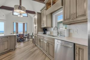 a large kitchen with wooden cabinets and a dining room at The Gulfview Grandeur in Pensacola Beach