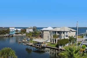 a large house on the water next to a dock at The Gulfview Grandeur in Pensacola Beach