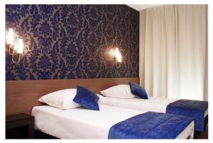 Posteľ alebo postele v izbe v ubytovaní Hotel Cztery Pory Roku