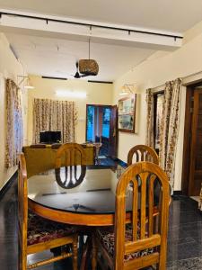 a dining room with a table and chairs at BEACHO 2 bhk private entire villa southcliff varkala in Varkala