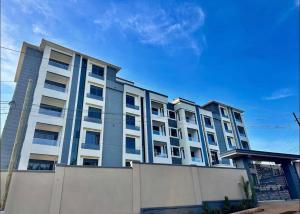 a large building with a fence in front of it at Mody Haven in Kampala